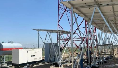 Workers assemble a metal framework for a large outdoor canopy on a flat rooftop, with scaffolding and a portable generator nearby.