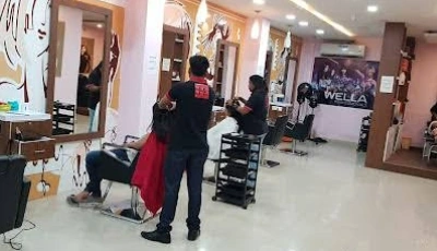 Hair salon interior with clients seated in styling chairs and stylists cutting hair along mirrors in a bright hallway.