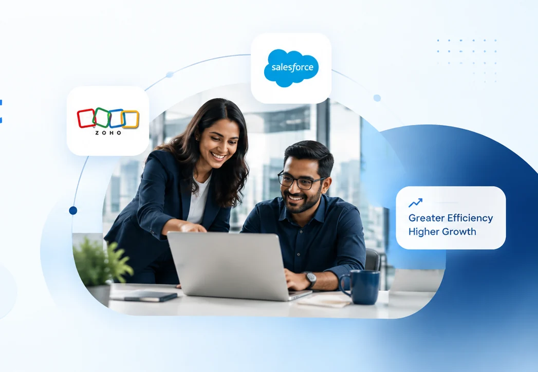 Two consultants reviewing a business system on a laptop, with Zoho and Salesforce logos